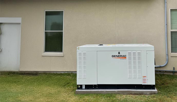 Generac backup generator unit installed on a concrete pad