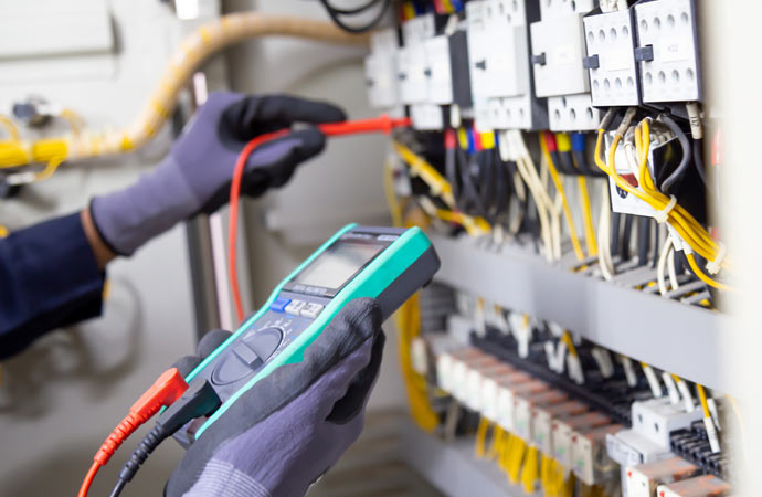 Electrician inspecting electrical installations in the image